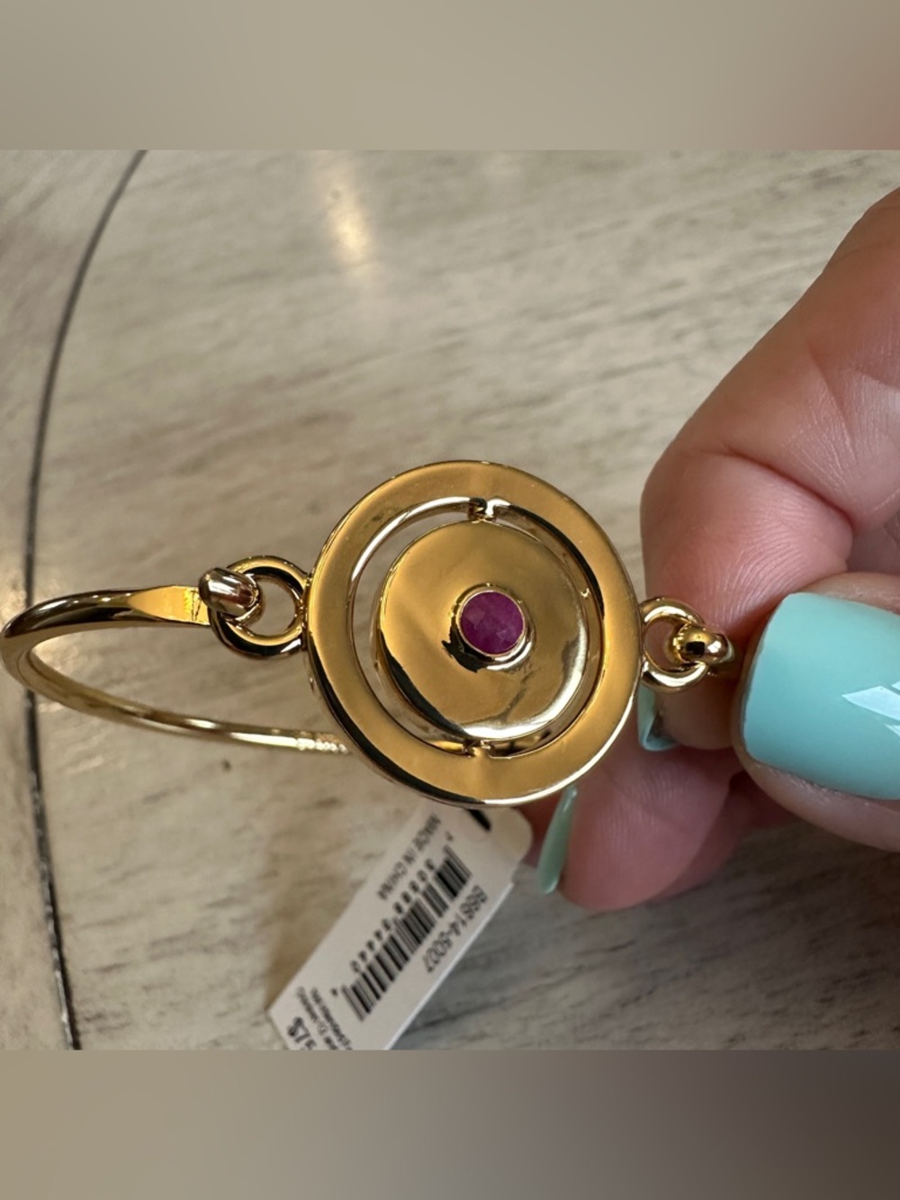 CAROLEE Gold-Tone Bangle Bracelet with Red Stone Flip-Disc July Accent